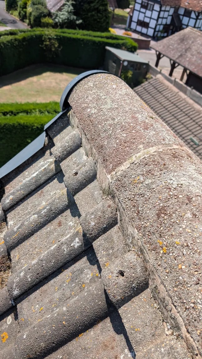 The same roof ridge and tiles clean and free of moss after cleaning